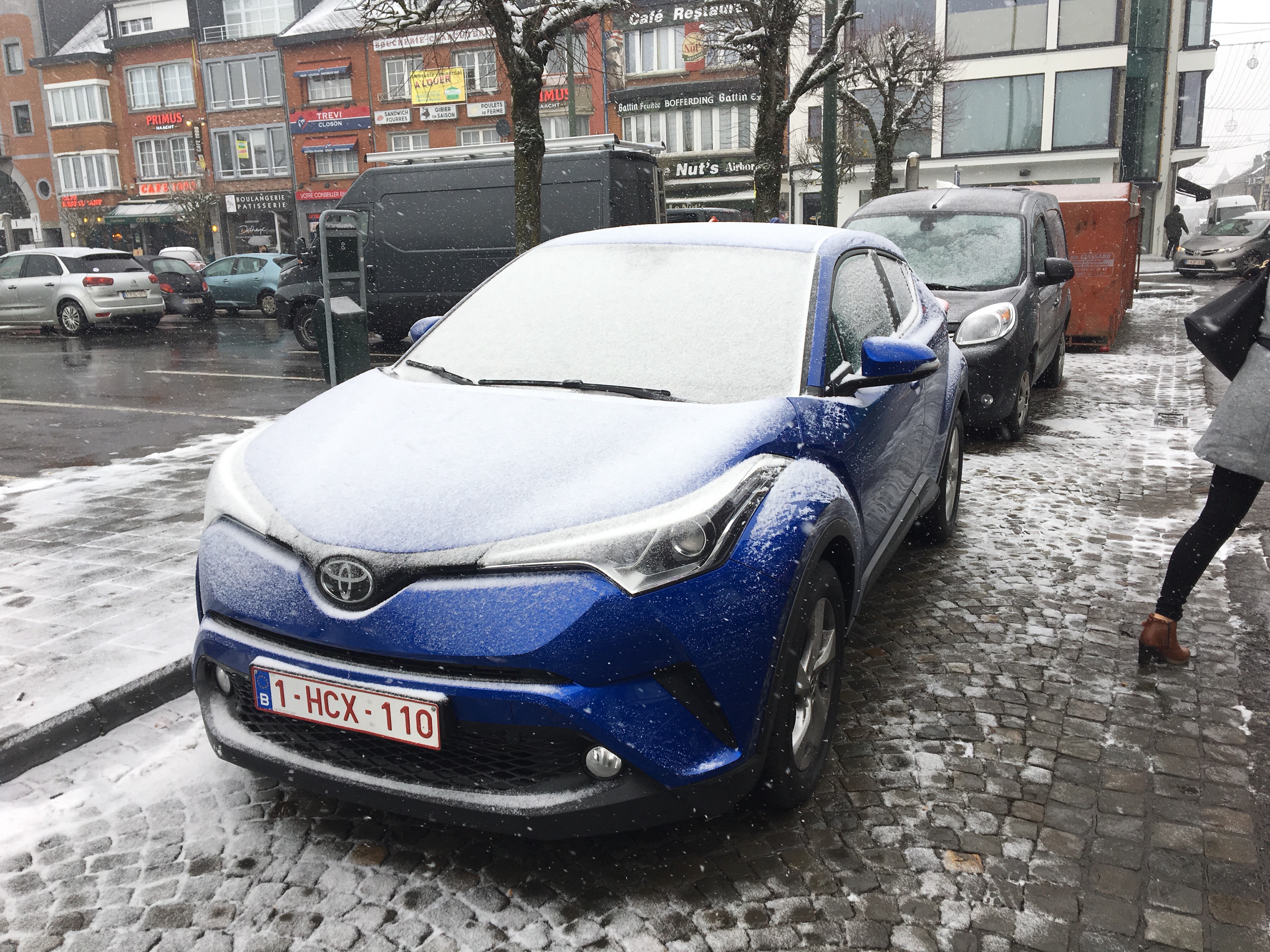 A nice car, covered in snow.