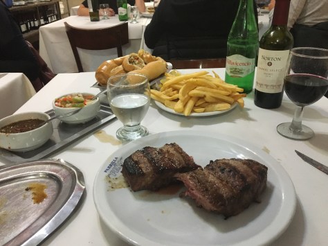 A dinner of steak and chips with Argentinian wine to go with it.
