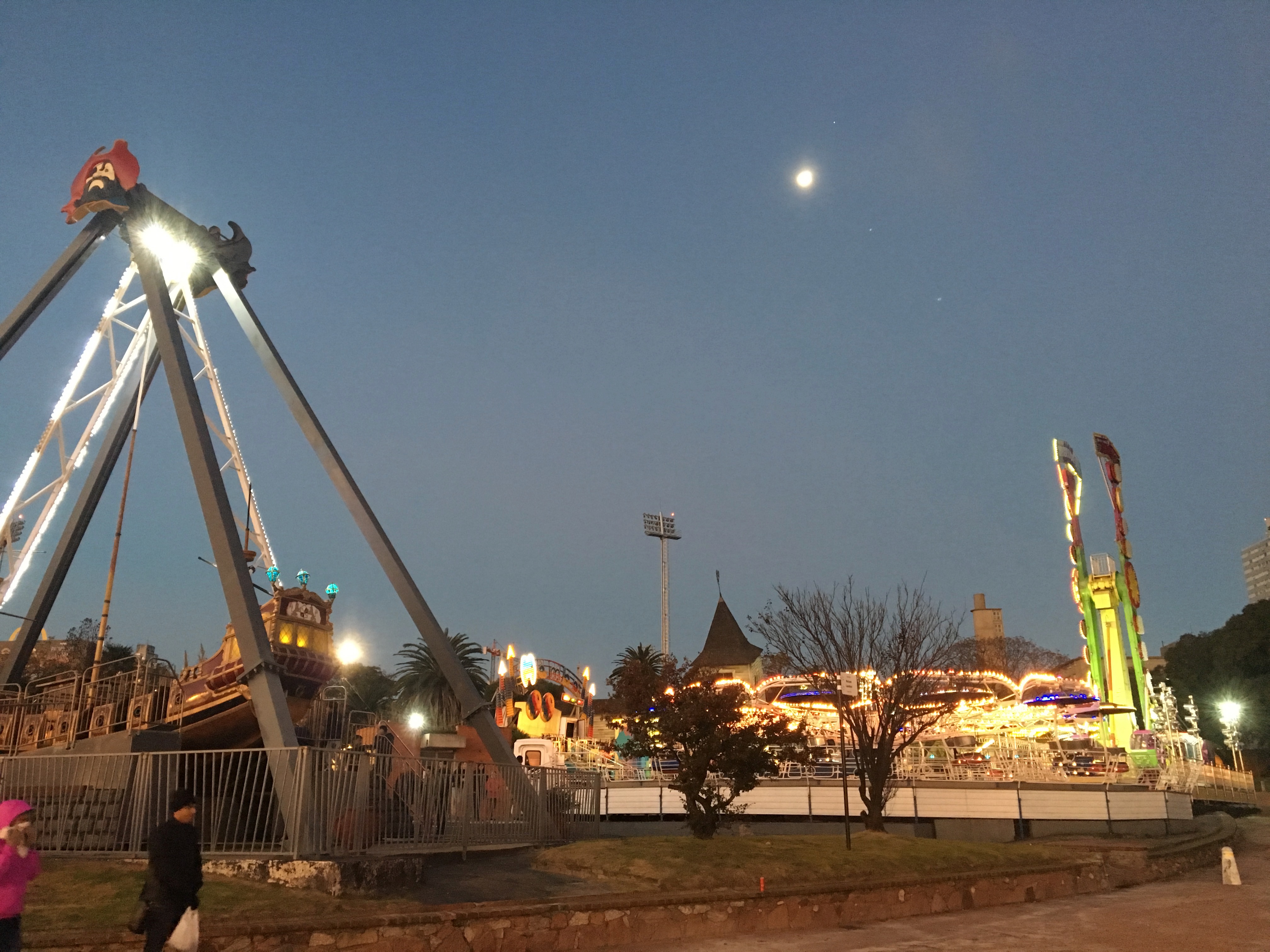 A funfair in Montevideo by moonlight.