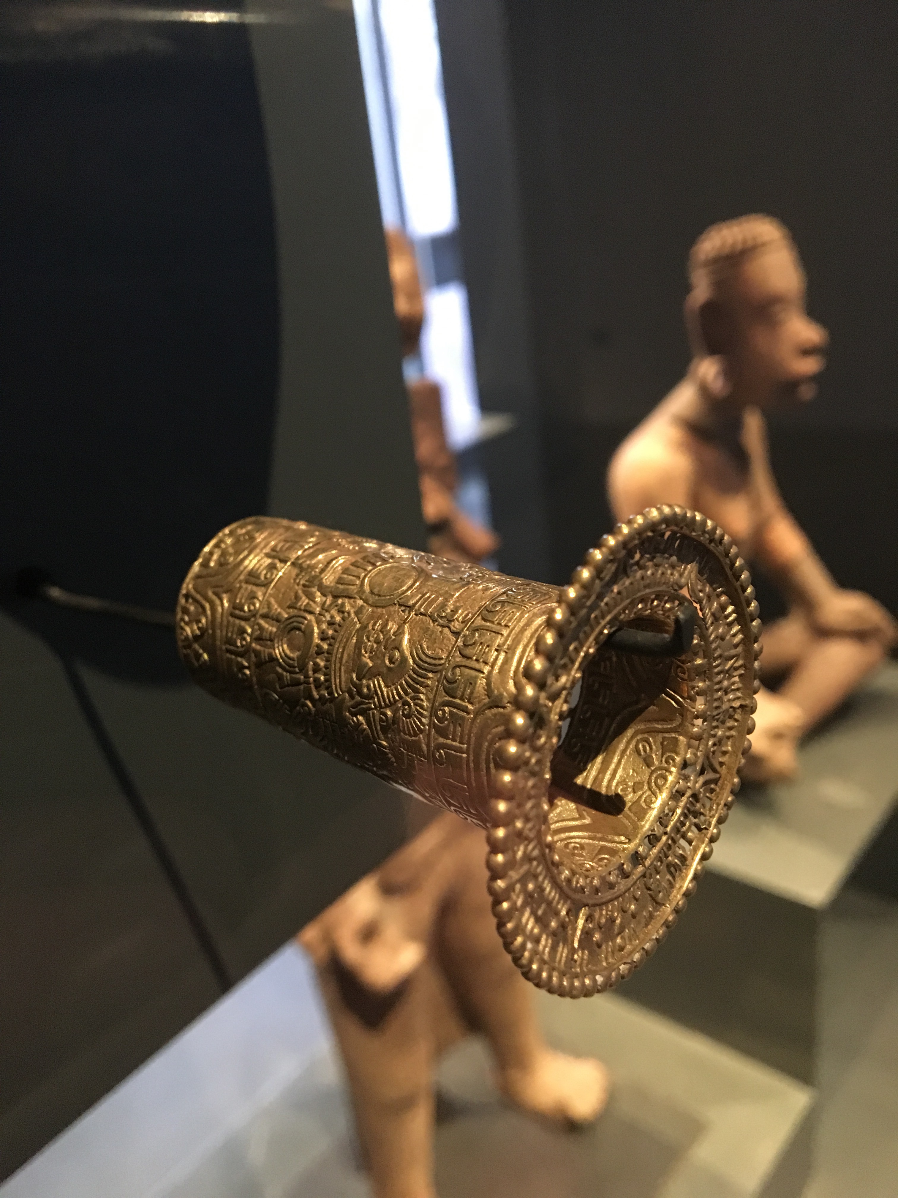 A golden ear ornament from pre-Colombian South America.