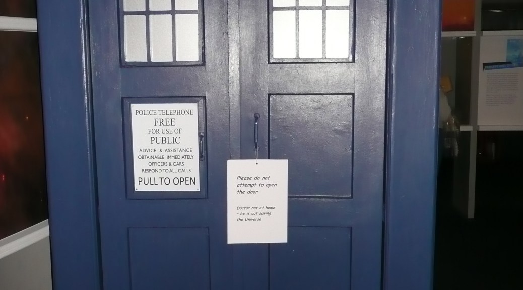 The Tardis from Doctor Who, with a sign saying that the Doctor is out.